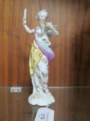 AN ANTIQUE HARD PASTE FIGURINE, as a female figure reading from a book, in the style of Serves, mar