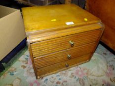 A TABLE TOP CHEST OF THREE DRAWERS