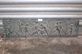 A METAL PANEL DEPICTING CHERUBS DRINKING AND PLAYING MUSIC - SIZE 18.75CM X 71.5CM
