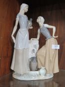 A LARGE NAO FIGURINE OF TWO LADIES COLLECTING WATER, H 39 cm, S/D