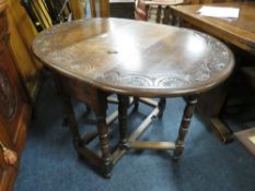 AN OAK CARVED DROPLEAF TABLE