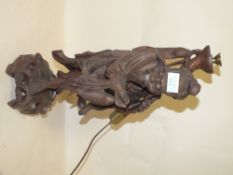 AN ORIENTAL CARVED HARD WOOD TABLE LAMP IN THE FORM OF A FISHERMAN, H 49 CM