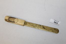 AN ORIENTAL STYLE BRASS PAGE TURNER WITH BONE HANDLE