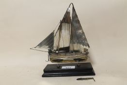 A CONTINENTAL STYLE STERLING SILVER MODEL OF A SAIL SHIP RAISED ON EBONISED PLINTH STAMPED 925 -