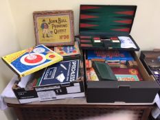 FOUR BOXES OF VINTAGE BOARD GAMES ETC., TOGETHER WITH A PAIR OF WOODEN STILTS
