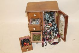 A JEWELLERY BOX CONTAINING COSTUME JEWELLERY