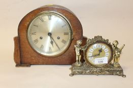 A SMALL GILT METAL DESK CLOCK TOGETHER WITH AN OAK MANTEL CLOCK