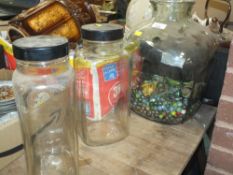 A LARGE GLASS JAR CONTAINING VINTAGE MARBLES TOGETHER WITH TWO SWEET JARS