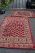 A VINTAGE RED WOOLLEN RUG