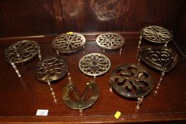 A COLLECTION OF BRASS TRIVETS