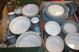 TWO TRAYS OF DENBY POWDER BLUE STONEWARE DINNERWARE TO INCLUDE CUTLERY, PLATES ETC.