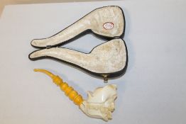 A CASED CARVED MEERSHAM STYLE PIPE WITH AMBER STYLE CHEROOT, CRACKED BY JOIN