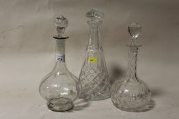 TWO CUT GLASS DECANTERS TOGETHER WITH AN ANTIQUE ETCHED GLASS DECANTER