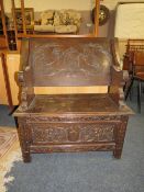 A CARVED OAK MONKS BENCH, W 83 CM