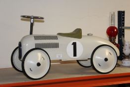 A CHILDS VILAC RIDE ON METAL TOY CAR