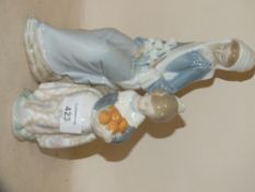TWO LLADRO FIGURES OF A YOUNG GIRL CARRYING ORANGES AND A SEATED LADY WITH FLOWERS