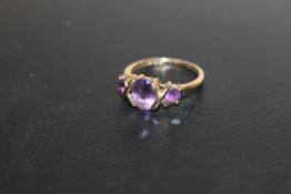 A HALLMARKED 9 CARAT GOLD THREE STONE AMETHYST RING, APPROX WEIGHT 2.2G