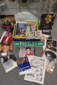 A BOX OF ELVIS PRESLEY MEMORABILIA TO INCLUDE CALENDARS, MODERN ENAMEL SIGNS ETC. AND A BOX OF