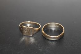 AN UNMARKED YELLOW METAL SIGNET RING, TOGETHER WITH A BAND STAMPED 9CT THREE TIMES (UNTESTED),