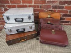 A SELECTION OF FOUR VINTAGE LEATHER BRIEFCASES, TWO ALUMINIUM CASES AND A WOODEN CASED DUPLICATOR