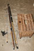 THREE FISHING RODS TOGETHER WITH A WICKER FISHING BOX (SIGNS OF WOODWORM)