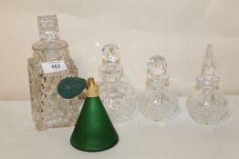 A COLLECTION OF CUT GLASS SCENT BOTTLES, DECANTER AND A GREEN GLASS ATOMISER (5)
