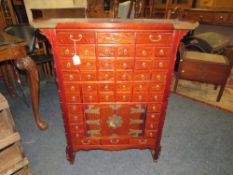 A CHINESE HARDWOOD APOTHECARY CHEST OF SLIM PROPORTIONS, having an arrangement of forty four drawers
