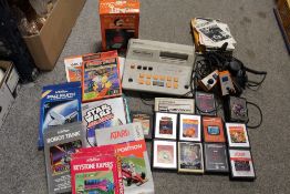 A TRAY OF VINTAGE VIDEO GAMES TO INCLUDE ATARI, BINATONE ETC.