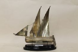 A CONTINENTAL STYLE STERLING SILVER MODEL OF A SAIL SHIP RAISED ON EBONISED PLINTH STAMPED 925
