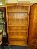 A MODERN OPEN HONEY PINE BOOKCASE - W 86 CM