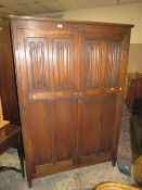AN OAK LINENFOLD TWO DOOR WARDROBE - H 178 CM, W 121 CM