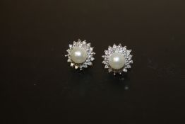 A PAIR OF UNMARKED DIAMOND AND FAUX PEARL EARRINGS