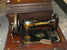 A MAHOGANY CASED VINTAGE SINGER SEWING MACHINE