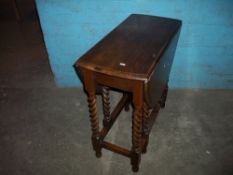 A BARLEY TWIST DROP LEAF TABLE