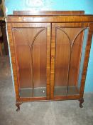 A VINTAGE GLAZED DISPLAY BOOKCASE WITH QUEEN ANNE LEGS