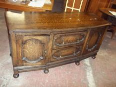 A REDUCED HEIGHT ANTIQUE OAK SIDEBOARD