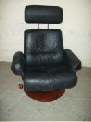 A BLACK LEATHER SWIVEL RECLINER CHAIR