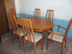 AN OVAL RETRO EXTENDING TEAK DINING TABLE AND SIX CHAIRS A/F