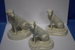 A BELLEEK COLLECTORS SOCIETY IRISH WOLFHOUND TOGETHER WITH A MATCHED PAIR OF SMALLER IRISH