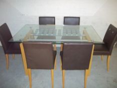 A GLASS DINING SET WITH SIX FAUX LEATHER CHAIRS