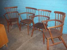 FOUR STICK BACK CARVER CHAIRS IN ERCOL STYLE, (SLIGHTLY DOGGY CHEWED)