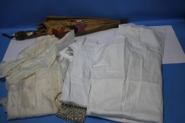 A VINTAGE PARASOL TOGETHER WITH A COLLECTION OF CHRISTENING GOWNS AND A LADIES PURSE