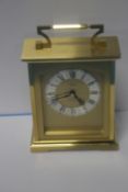 AN ANGELUS BRASS CLOCK