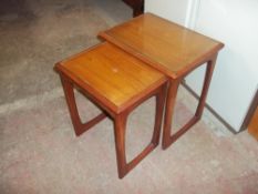 A RETRO TEAK NEST OF TWO TABLES WITH GLASS INSERTS