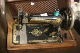 A CASED SINGER SEWING MACHINE`