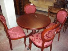 A MODERN ROUND MAHOGANY DINING TABLE AND FOUR BALLOON BACKED CHAIRS