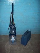 A VAX CARPET CLEANER AND A STEEL TOOL BOX
