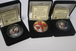 A POPE JOHN PAUL II 25TH ANNIVERSARY 999 SILVER COLOURIZED US EAGLE AND TWO OTHER COLOURIZED COINS