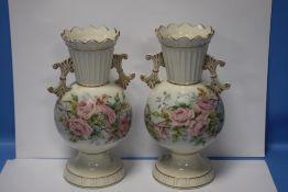A PAIR OF BELLEEK HAND PAINTED FLORAL TWIN HANDLED VASES WITH BLACK MARKS TO BASE, H APPROXIMATELY