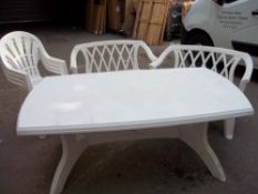 A PLASTIC GARDEN SET INCLUDING A TABLE, TWO STACKING BENCHES AND FOUR STACKING CHAIRS